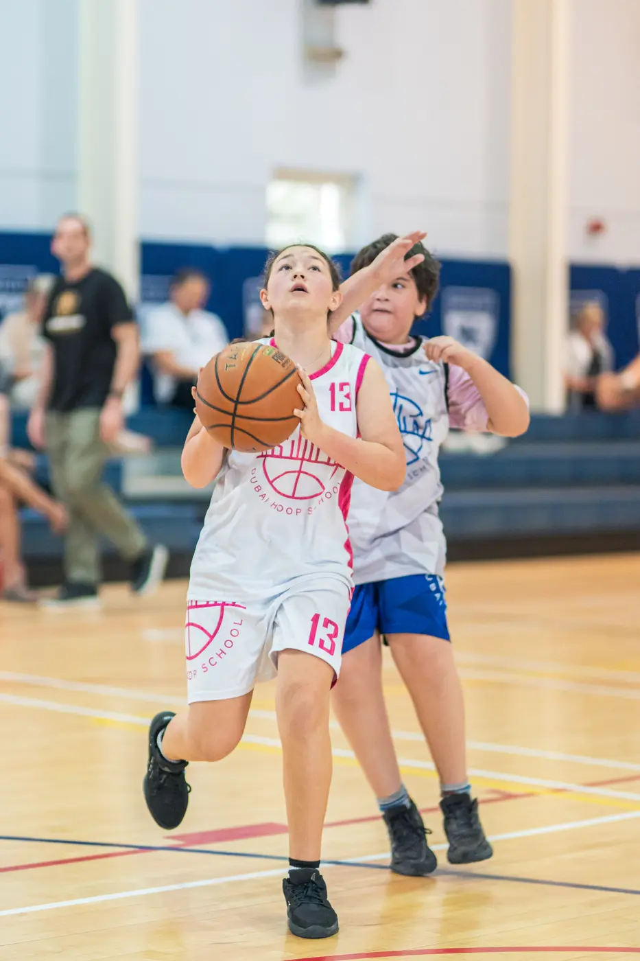 Girl playing basketball for Dubai Hoop School